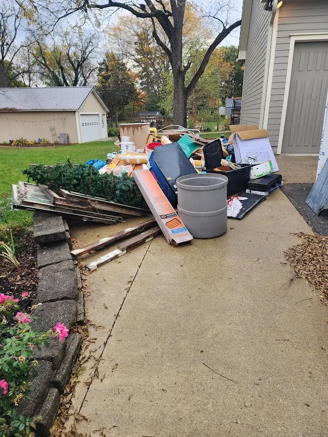 Dumpster being loaded with debris for Demolition Dumpster Rental in Maplewood